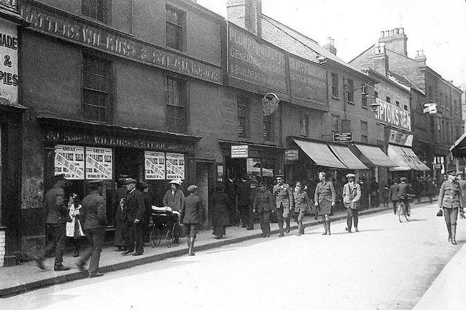 The range of Great War-era uniforms on display here puts the time period of this photo squarely between 1914-1918.