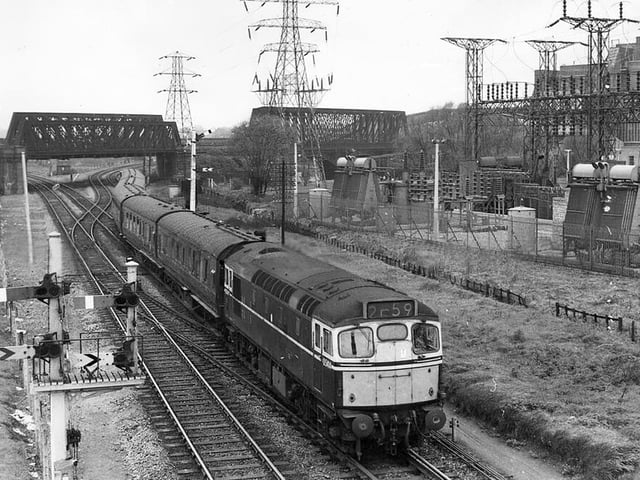 A May Bank Holiday train from Leicester cruises down from the East Coast Mainline towards Peterborough East station in 1964.