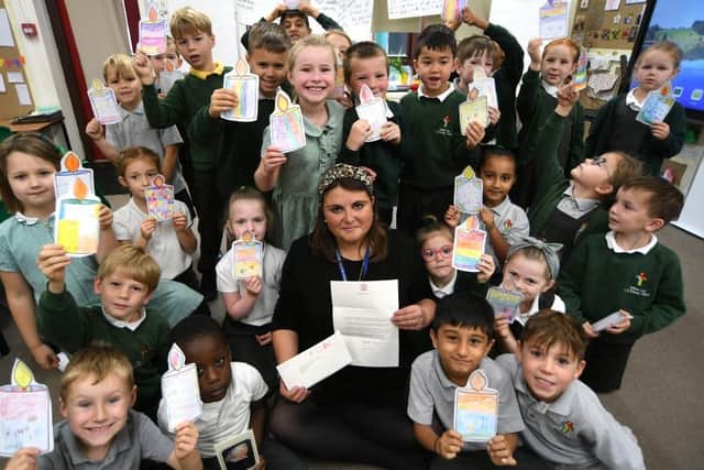 Teacher, Laura Currie, with her year two pupils at William Law CE primary school. The pupils may be one of the last classes to receive a letter from Queen Elizabeth II's royal household.