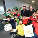 Football crazy pupils in six year at All Saints have rallied together to raise thousands for charity - Junaid Javed (bottom left) and Hisham Farooq (bottom right). Teaching staff Tim Street (left, top) and David Lowings (right, top). Image: David Lowndes