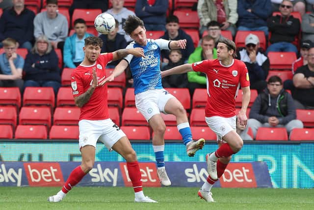 Joel Randall (blue) in action for Posh.