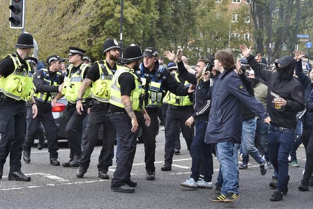 Police and football fans in the city centre before the Peterborough United vs Cambridge United match in October.