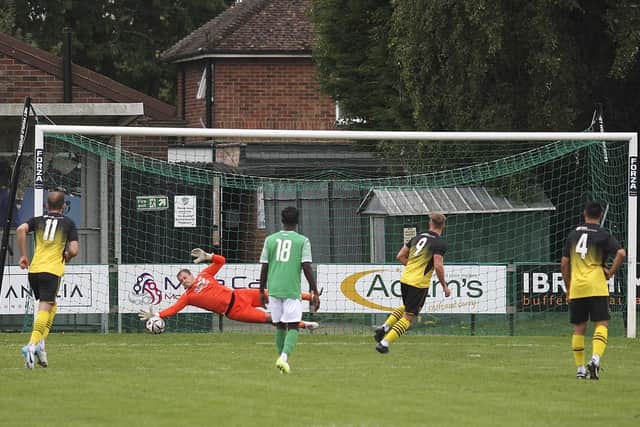 FC Peterborough goalkeeper Sash Snitkas saves a penalty in the game against Stanway Pegasus. Photo: Tim Symonds