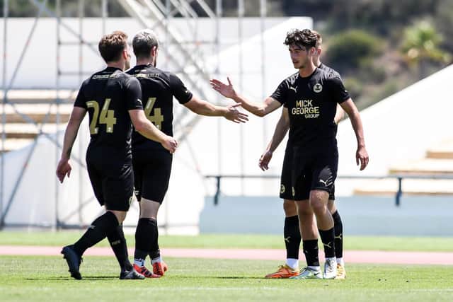 Posh forward Joel Randall celebrates his goal against Orient with team-mates. Joe Dent/theposh.com