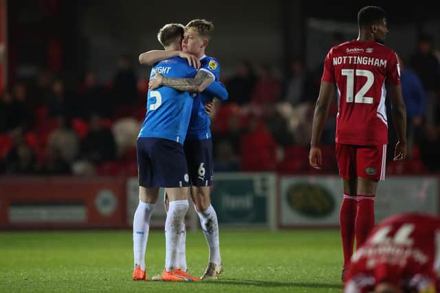 Josh Knight and Frankie Kent of Peterborough United celebrate the victory over Accrington Stanley at full-time. Photo: Joe Dent/theposh.com.