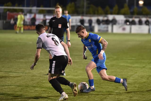 Jordan Crawford (blue) in action for Peterborough Sports v Scarborough Athletic. Photo: David Lowndes.