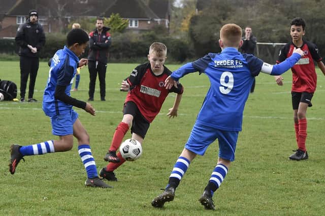 Action from Netherton (red) v Feeder Under 12s at the Grange. Photo: David Lowndes.