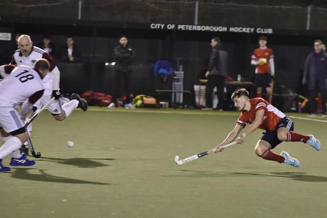 Hockey action from City of Peterborough (red) v Bedford at Bretton Gate. Photo David Lowndes.