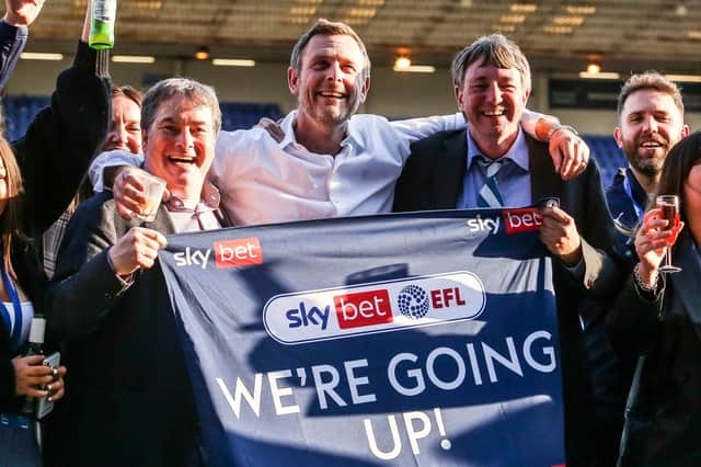 From the left, Stewart Thompson, Darragh MacAnthony and Jason Neale celebrate a Posh promotion in May 2021. Photo: Joe Dent/theposh.com