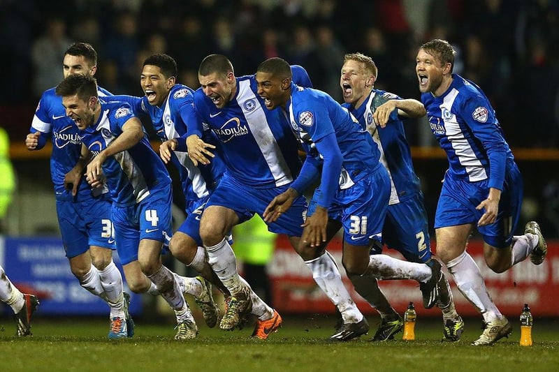 Peterborough United's players celebrate their 4-3 win on penalties after Tommy Rowe converted the winning penalty during the Johnstone's Paint Southern Area final second leg match with Swindon Town at the County Ground on February 17, 2014