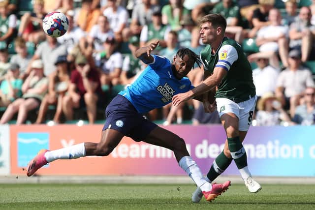 Ricky-Jade Jones of Peterborough United battles with Joe Edwards of Plymouth Argyle. Photo: Joe Dent/theposh.com.