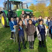 Children with Farmer James, learning all about the tractor's role on a farm