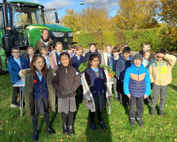 Children with Farmer James, learning all about the tractor's role on a farm