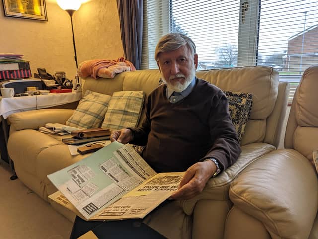 Abdul Choudhuri at home with a scrapbook of cuttings from his work in Peterborough