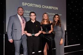 Year 6 pupil Cara Melville receives her Sporting Champion award.