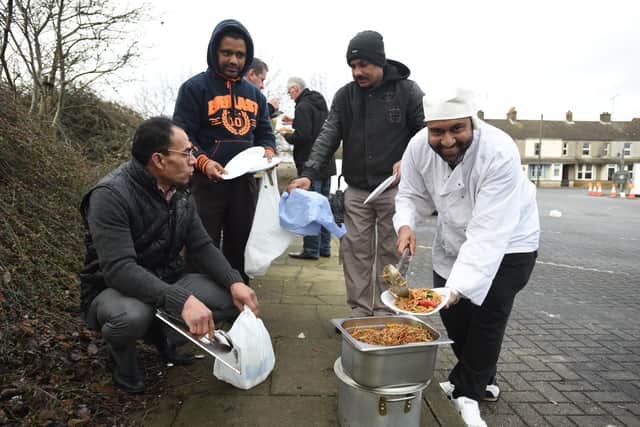Chef Mohammed Saiful Islam and volunteers from the Zi Foundation handing out food to the homeless at car park behind the Brewery Tap.