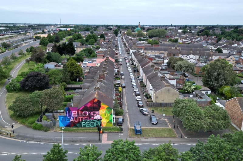 Beautiful shot showing the length of Gladstone Street, with Nathan Murdoch's colourful mural in the foreground and the stunning Faizan-e-Medina Mosque in the distance.