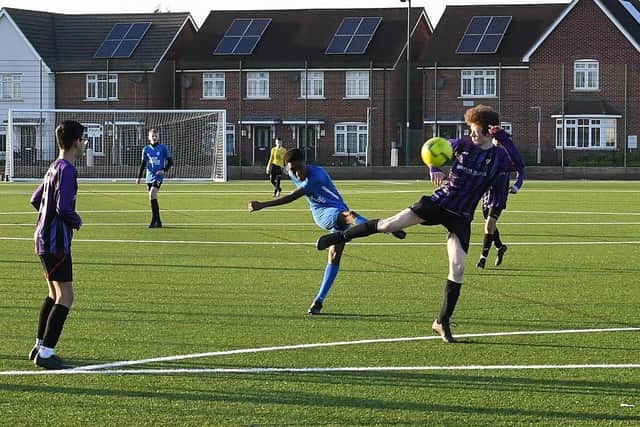 Football action from the schools cup final between Jack Hunt and Nene Park Academy (blue) at St John Fisher. Photo: David Lowndes