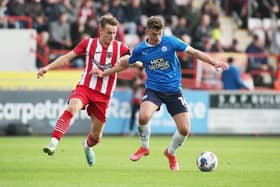 Harrison Burrows of Peterborough United battles with Archie Collins of Exeter City last season. Photo: Joe Dent.