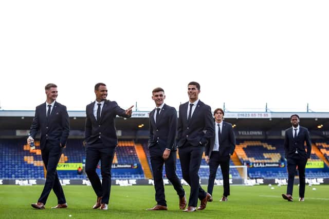 Peterborough United players arrive at Mansfield Town wearing their Marc Darcy suits. Photo: Joe Dent/theposh.com.