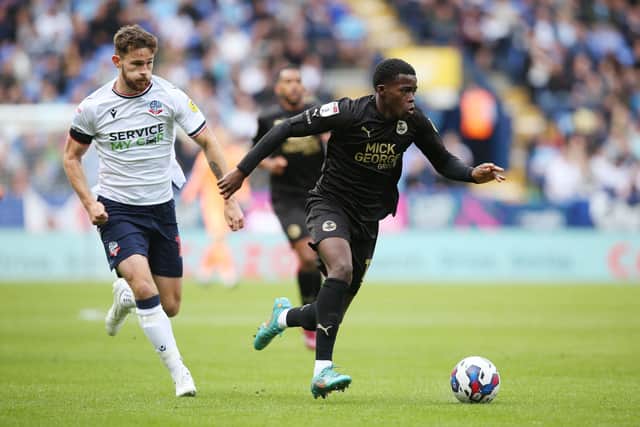 Bolton's Jack Iredale, seen here chasing Posh star Kwame Poku, will miss the big game at London Road. Photo: Joe Dent/theposh.com.