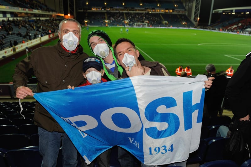 Peterborough fans wear face masks refering to reports of Blackburn Rovers players contracting Swine Flu before the Carling Cup 4th Round match at Ewood Park on October 27, 2009.