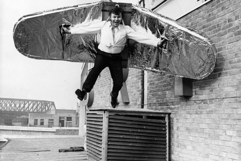 A stuntman tries out his balsa wood wings on the roof of a supermarket in preparation for his attempt to fly across the River Nene at Peterborough on 10th February 1971.