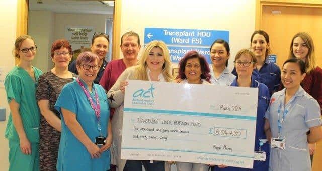 Maggie Mooney and friend Sheridan Gaunt presenting a cheque to the Addenbrooke's Charitable Trust in 2019.