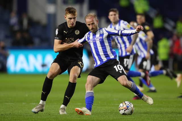 Hector Kyprianou of Peterborough United battles with Barry Bannan of Sheffield Wednesday. Photo: Joe Dent/theposh.com.