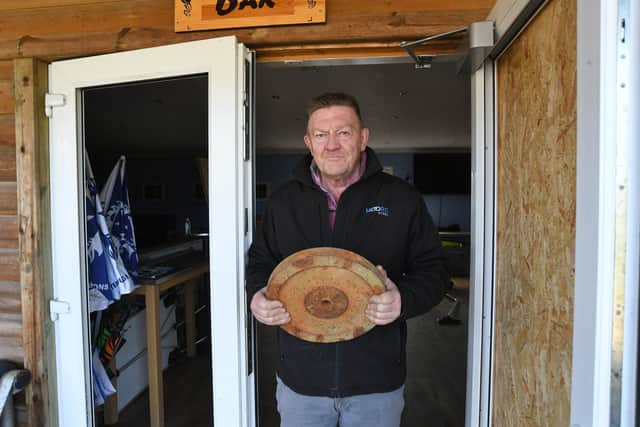 Peterborough Lions Rugby Club Andy Moore at  Peterborough Lions with the weight used to smash glass in the clubhouse.