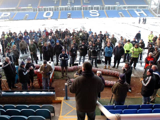 Football fans descended on London Road to help clear the snow off the pitch before Peterborough United's game against West Ham,