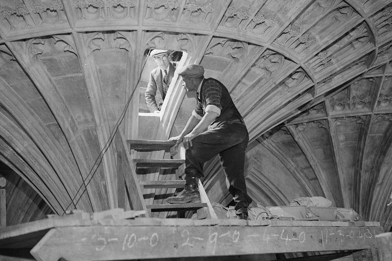 Men at work restoring the ornately carved ceiling in the Eastern Chapel of Peterborough Cathedral on 3rd April 1935.