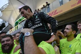 Mercedes' British driver George Russell celebrates with his team after winning the Formula One Brazil Grand Prix.