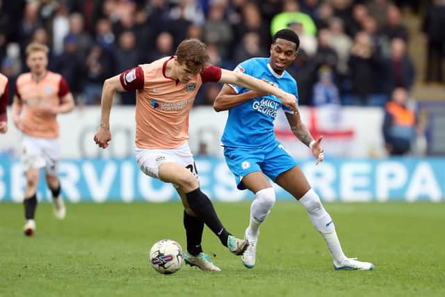 Sean Raggett battling with Posh striker Malik Mothersille last season. Photo Joe Dent/theposh.com