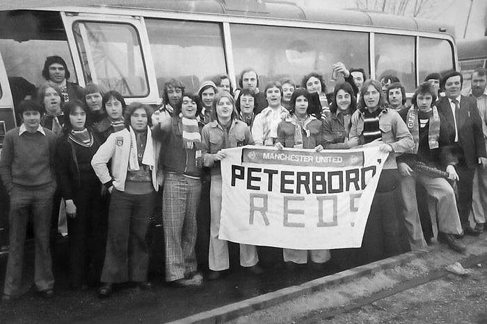 With baggies and boots all ready, the Peterborough branch of the Manchester United Supporters Club about to head off from Bishops Road Bus station on a 1970s game day.