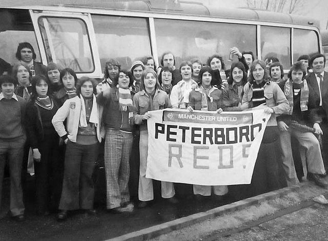 With baggies and boots all ready, the Peterborough branch of the Manchester United Supporters Club about to head off from Bishops Road Bus station on a 1970s game day.