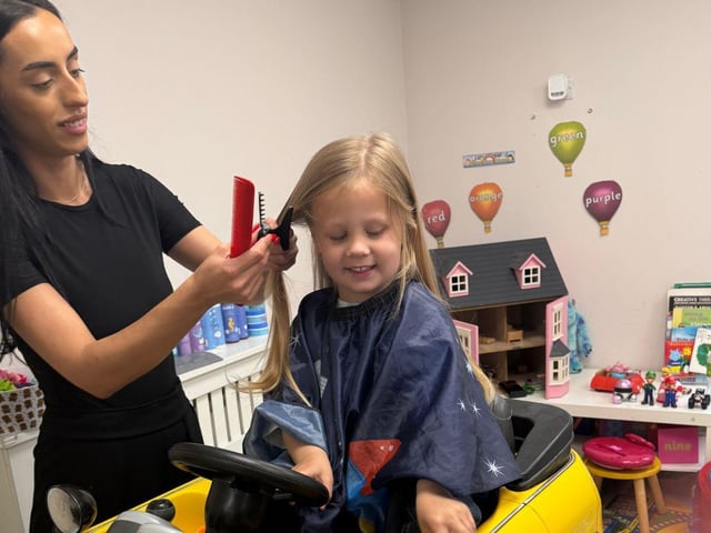 Tom Butler (3) of Peterborough has his haircut by Erica for the Little Princess Trust