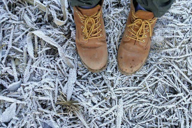 Image shows feet on frosty ground