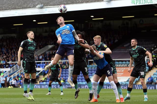 Frankie Kent of Peterborough United challenges for the ball against Bristol Rovers. Photo: Joe Dent/theposh.com.
