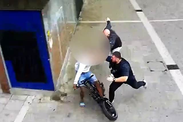 The moment the e-bike rider is tackled to the floor