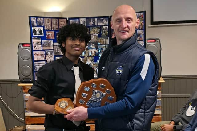 Sid Shanmugaraj receives his award from East cricket official Will Sneath.