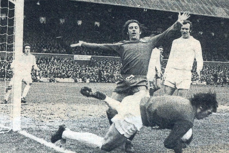 Posh legend Tommy Robson is just beaten to the ball by Leeds United goalkeeper David Harvey in 1974. Paul Madeley of Leeds is close by.