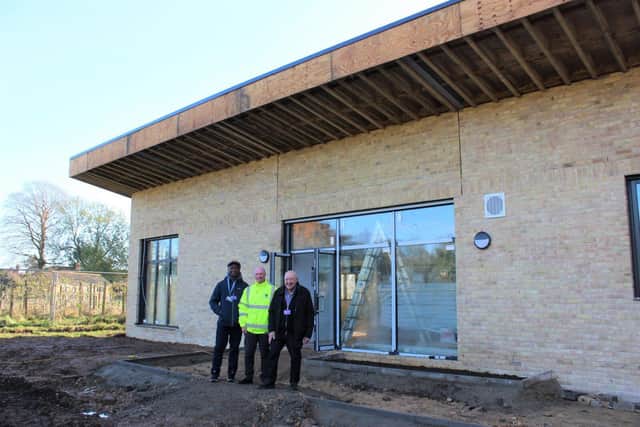Pictured outside the progressing Wisbech Park community pavilion are, from left, Cllr Sidney Imafido