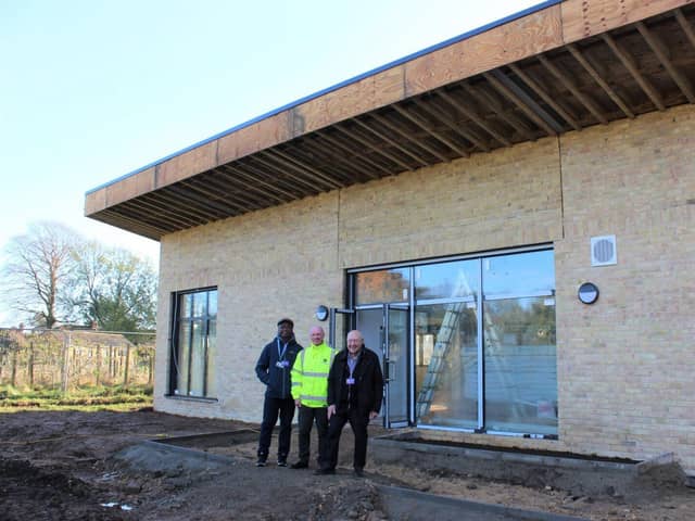 Pictured outside the progressing Wisbech Park community pavilion are, from left, Cllr Sidney Imafido