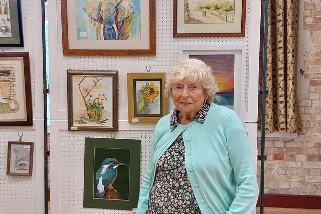 The winner of the Festival painting competition - Pat Borne - with her winning entry of a Kingfisher.