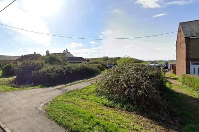 The land off Upwell Road (pictured) could become home to more than 100 new buildings