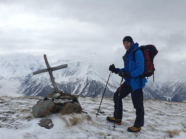 Pawel pictured at a summit cross in the Aosta Valley, Alps.