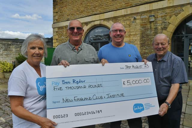 Elaine Rignall from Sue Ryder with Graham Ward, Jeff Millen and  Terry Nottingham representing members and past members of the New England Club presenting the charity with a £5,000 cheque.