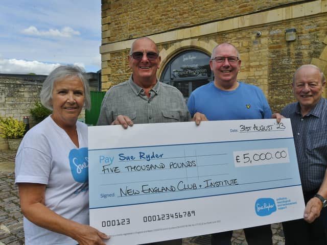 Elaine Rignall from Sue Ryder with Graham Ward, Jeff Millen and  Terry Nottingham representing members and past members of the New England Club presenting the charity with a £5,000 cheque.