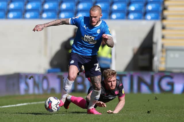 Joe Ward of Peterborough United skips past a challenge from an Exeter City defender. Photo: Joe Dent/theposh.com.